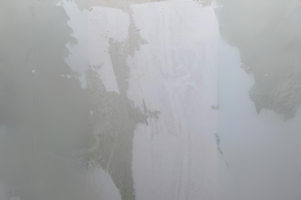 Technician assessing water damage on a ceiling